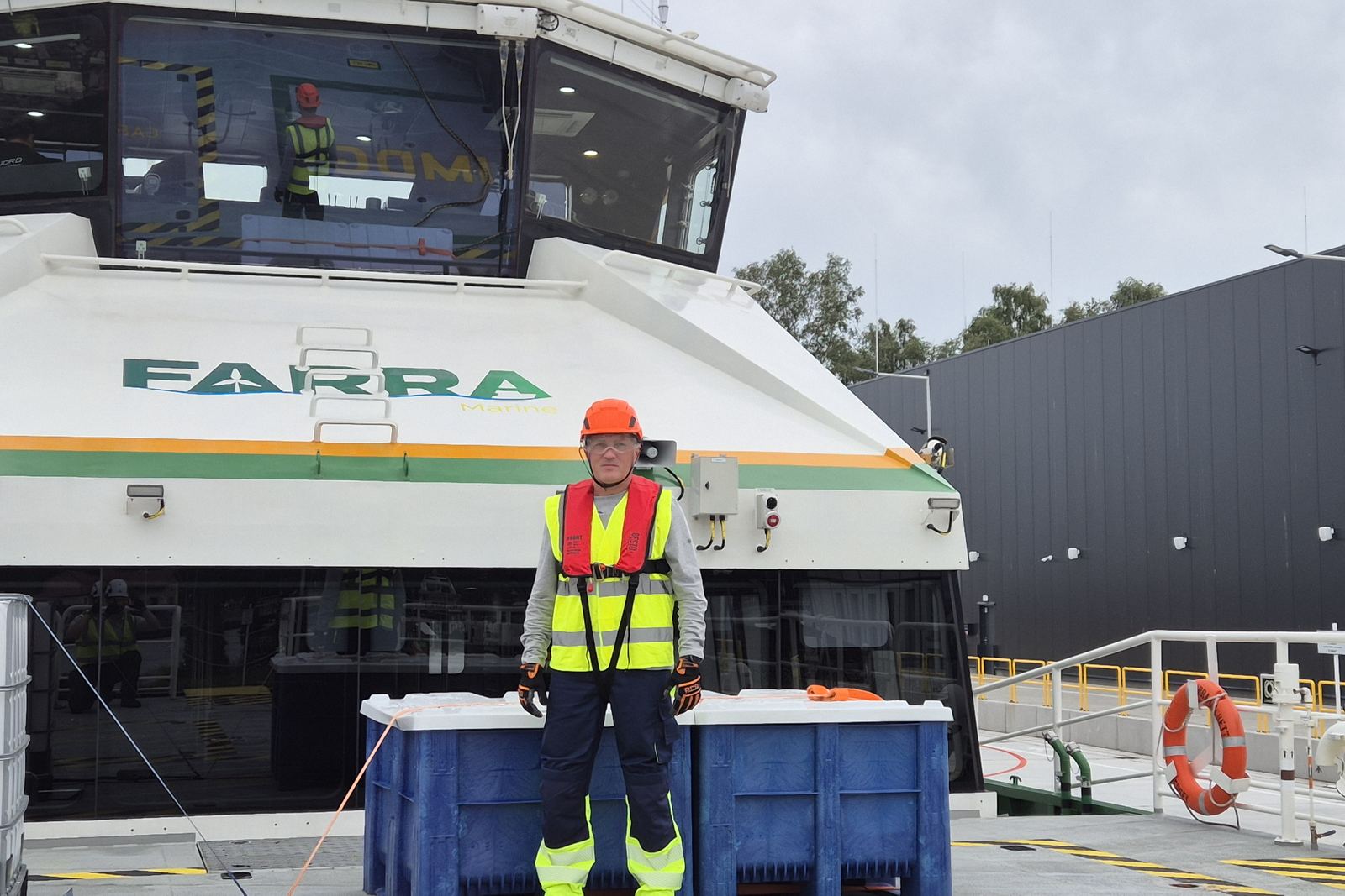 Inspector in hi-vis on the deck of a crew transfer vessel