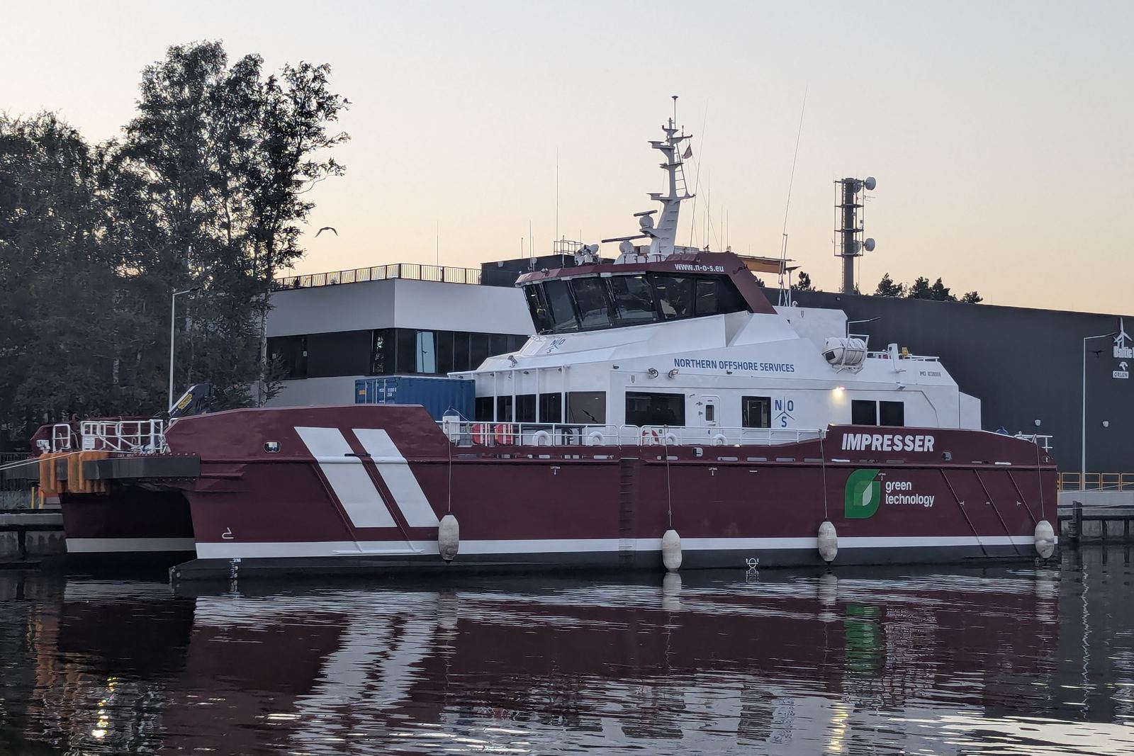 Crew transfer vessel moored at dusk